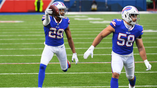 The Bills' Josh Norman (29) gestures as he returns an interception for a touchdown as outside linebacker Matt Milano (58) assists against the Miami Dolphins.