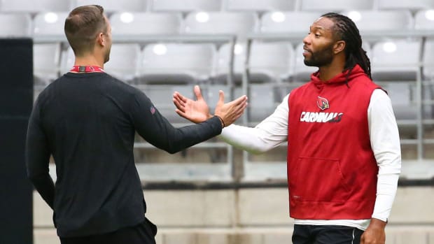 Arizona Cardinals head coach Kliff Kingsbury greets Larry Fitzgerald during the conditioning test at training camp on July 24, 2019 in Glendale, Ariz.