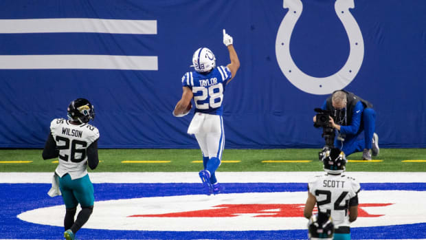 Indianapolis Colts running back Jonathan Taylor points skyward after scoring a touchdown in a Week 17 home win over the Jacksonville Jaguars at Lucas Oil Stadium.