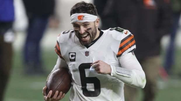 Baker Mayfield smiles as he runs off the field