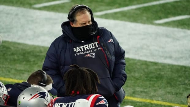 Bill Belichick stands on the sidelines during a game