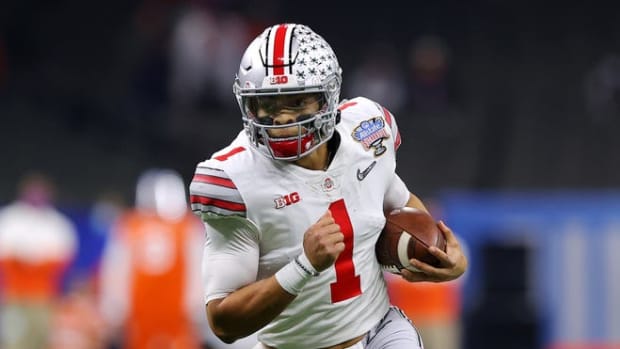 Justin Fields runs with the football in the Allstate Sugar Bowl against the Clemson Tigers