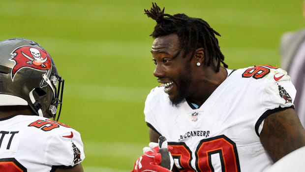 Bucs defensive end Jason Pierre-Paul smiles on the sideline during a game