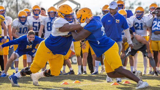McNeese football players tackle during a spring practice