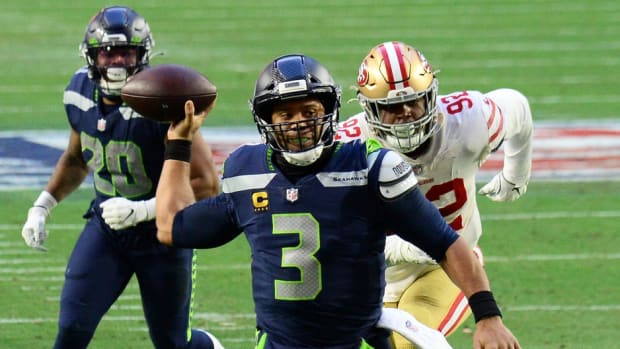 Jan 3, 2021; Glendale, Arizona, USA; Seattle Seahawks quarterback Russell Wilson (3) throws a touchdown pass against the San Francisco 49ers during the second half at State Farm Stadium. Mandatory Credit: Joe Camporeale-USA TODAY Sports