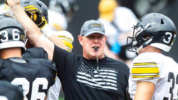 Chris Doyle huddles up with players during a Hawkeyes football Kids Day scrimmage, Saturday, Aug. 10, 2019, at Kinnick Stadium.