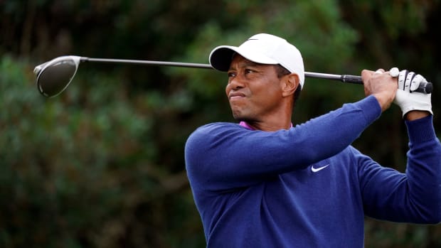 Tiger Woods plays his shot from the 18th tee during continuation of the second round of The Masters golf tournament at Augusta National GC.