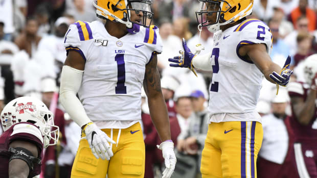 Oct 19, 2019; Starkville, MS, USA; LSU Tigers wide receiver Ja'Marr Chase (1) and wide receiver Justin Jefferson (2) react after a touchdown against the Mississippi State Bulldogs during the second quarter at Davis Wade Stadium. Mandatory Credit: Matt Bush-USA TODAY Sports