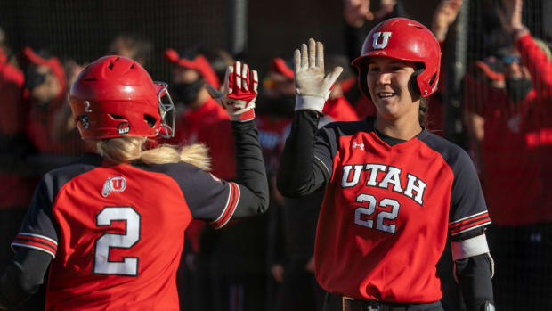 Utah softball's Ellessa Bonstrom (2) high-fives teammate Halle Morris (22) during the UNLV Desert Classic — Courtesy of Utah Athletics