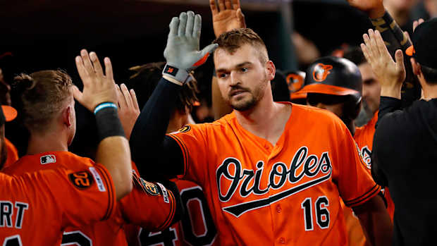 Trey Mancini high fives Orioles teammates in the dugout