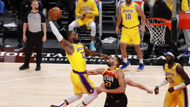 Feb 24, 2021; Salt Lake City, Utah, USA; Los Angeles Lakers forward LeBron James (23) dunks the ball over Utah Jazz center Rudy Gobert (27) during the second quarter at Vivint Smart Home Arena. Mandatory Credit: Chris Nicoll-USA TODAY Sports