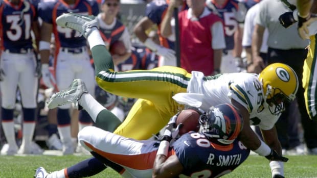 Green Bay Packers Leroy Butler knocks down Bronco receiver Rod Smith after a reception during first half play against the Denver Broncos on Sunday, Aug. 13, 2000 at Mile High Stadium in Denver. Rod Smith Of Denver And Leroy Butler Of The Packers