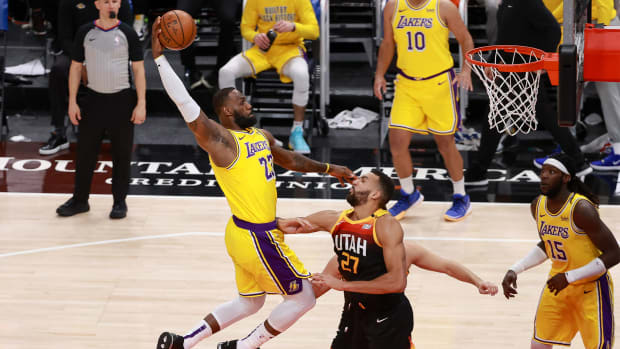 Feb 24, 2021; Salt Lake City, Utah, USA; Los Angeles Lakers forward LeBron James (23) dunks the ball over Utah Jazz center Rudy Gobert (27) during the second quarter at Vivint Smart Home Arena.