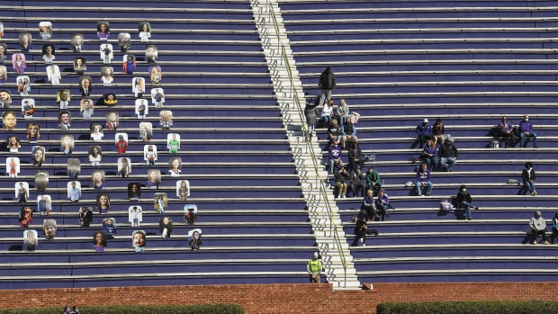 Fans at a Furman football game this spring sit one section away from cardboard cutouts.