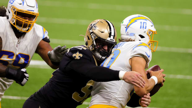 Oct 12, 2020; New Orleans, Louisiana, USA; New Orleans Saints defensive end Trey Hendrickson (91) sacks Los Angeles Chargers quarterback Justin Herbert (10) during the first quarter at the Mercedes-Benz Superdome. Mandatory Credit: Derick E. Hingle-USA TODAY Sports