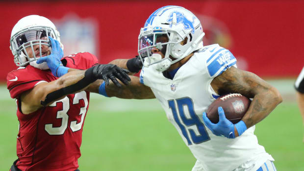 Lions receiver Kenny Golladay stiff-arms a defender during a win over the Cardinals