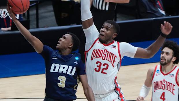 Oral Roberts Golden Eagles guard Max Abmas (3) shoots the ball against Ohio State Buckeyes forward E.J. Liddell (32) and guard Duane Washington Jr. (4) during the second half