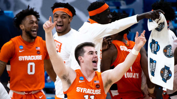 Syracuse Orange guard Joseph Girard III (11) and other players celebrate after their 75-72 victory over the West Virginia Mountaineers during the second round of the 2021 NCAA Tournament