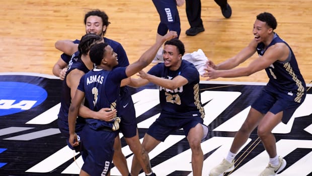 Oral Roberts players celebrate after winning NCAA tournament game