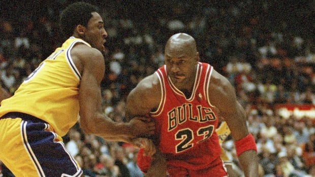 Michael Jordan is held up by Los Angeles Lakers Kobe Bryant in 1998.