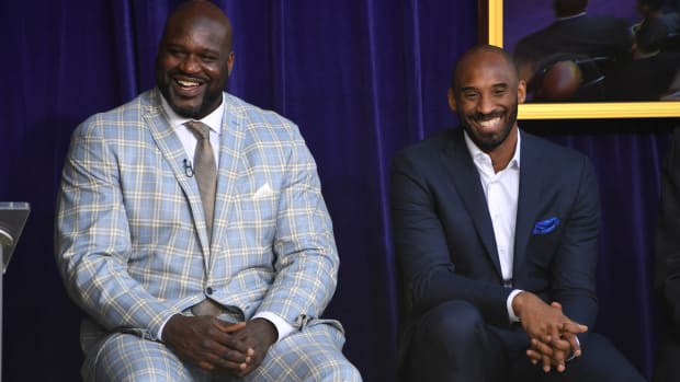 Los Angeles Lakers former center Shaquille O'Neal and guard Kobe Bryant react during ceremony to unveil statue of O'Neal at Staples Center.