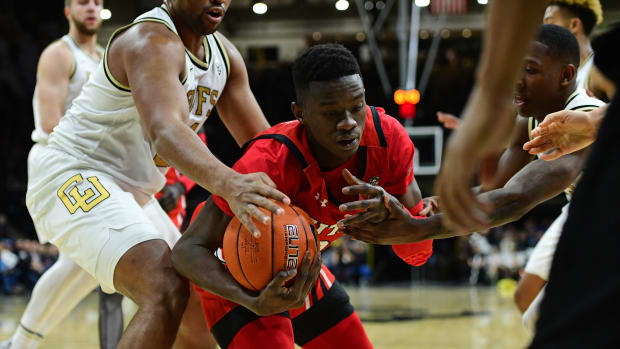 Jan 12, 2020; Boulder, Colorado, USA; Colorado Buffaloes forward Evan Battey (21) and Utah Utes center Lahat Thioune (32) reach for a loose ball in the second half at the CU Events Center.