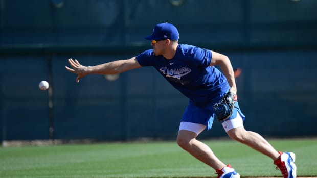 Feb 15, 2020; Glendale, Arizona, USA; Los Angeles Dodgers left fielder Enrique Hernandez (14) flips the ball during a spring training workout at Camelback Ranch. Mandatory Credit: Joe Camporeale-USA TODAY Sports