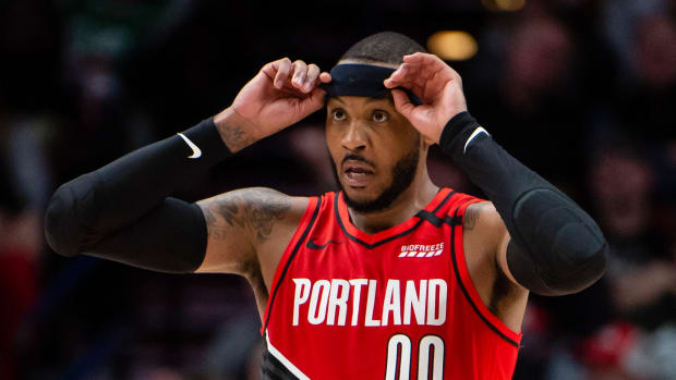 Trail Blazers forward Carmelo Anthony adjusts his headband during a game vs. the Celtics.
