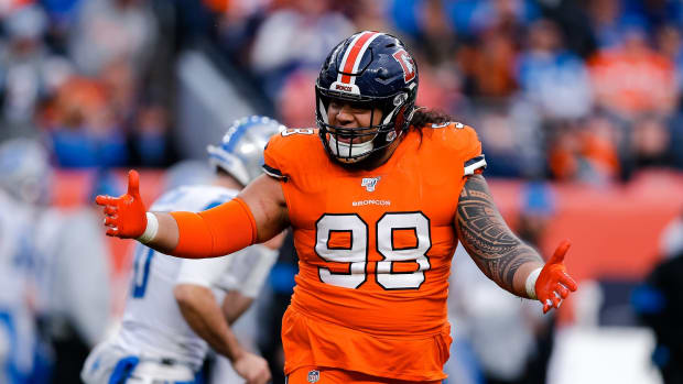 Denver Broncos nose tackle Mike Purcell (98) reacts after a play against the Detroit Lions in the third quarter at Empower Field at Mile High.