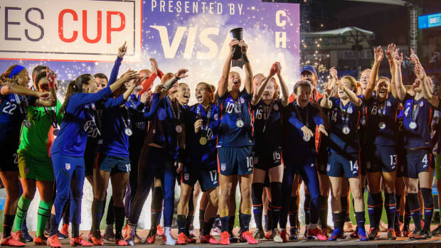 The U.S. women's national team celebrating with a trophy