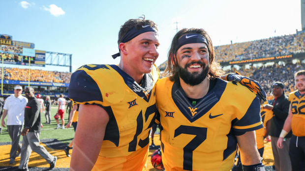West Virginia Mountaineers wide receiver David Sills V (13) and West Virginia Mountaineers quarterback Will Grier (7) celebrate after beating the Texas Tech Red Raiders at Milan Puskar Stadium.