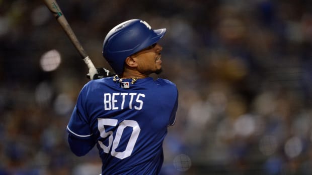 Mar 4, 2020; Phoenix, Arizona, USA; Los Angeles Dodgers right fielder Mookie Betts (50) bats against the San Francisco Giants during the third inning of a spring training game at Camelback Ranch. Mandatory Credit: Joe Camporeale-USA TODAY Sports