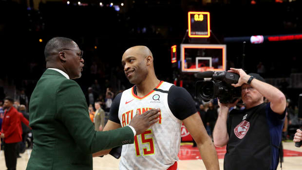Mar 11, 2020; Atlanta, Georgia, USA; NBA Hall of Fame player Dominique Wilkins (left) greets Atlanta Hawks guard Vince Carter (15) after a Hawks overtime loss to the New York Knicks at State Farm Arena. Mandatory Credit: Jason Getz-USA TODAY Sports
