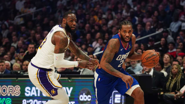 Mar 8, 2020; Los Angeles, California, USA; LA Clippers forward Kawhi Leonard (2) dribbles the ball past Los Angeles Lakers forward LeBron James (23) in the second half at Staples Center.