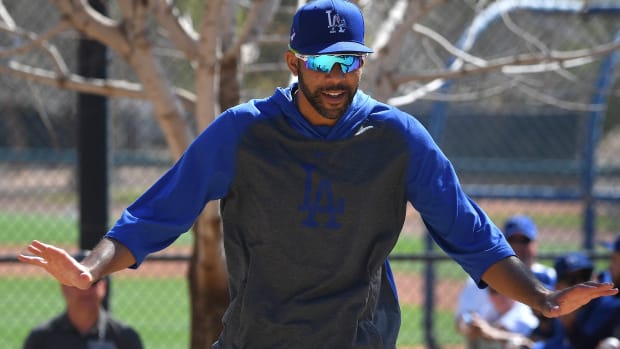 Feb 20, 2020; Glendale, Arizona, USA; Los Angeles Dodgers starting pitcher David Price (33) runs back to the clubhouse past fans during spring training at Camelback Ranch. Mandatory Credit: Jayne Kamin-Oncea-USA TODAY Sports