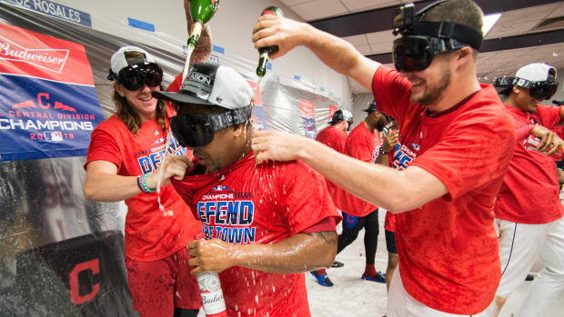 Sep 15, 2018; Cleveland, OH, USA; Cleveland Indians starting pitcher Mike Clevinger (left) and second baseman Jose Ramirez (middle) and starting pitcher Trevor Bauer (right) celebrate after defeating the Detroit Tigers to clinch the American League Central Division at Progressive Field.