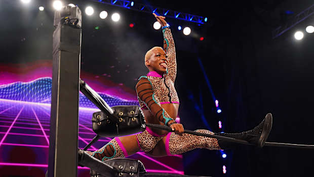 AEW's Sonny Kiss poses atop the ring ropes