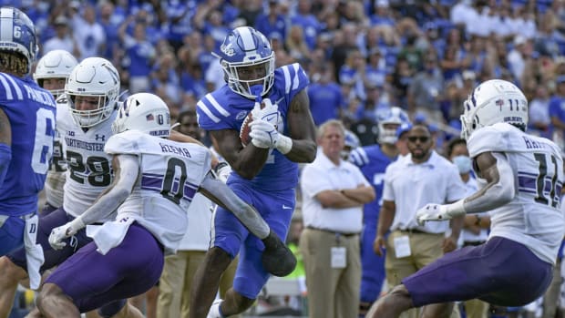 Sep 18, 2021; Durham, North Carolina, USA; Duke Blue Devils running back Jordan Waters (7) makes a cut to break a tackle by Northwestern Wildcats defensive back Coco Azema (0) during the second quarter at Wallace Wade Stadium. Mandatory Credit: William Howard-USA TODAY Sports