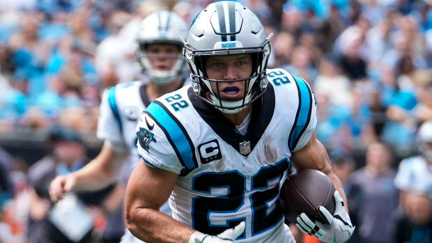 Sep 19, 2021; Charlotte, North Carolina, USA; Carolina Panthers running back Christian McCaffrey (22) takes the handoff from quarterback Sam Darnold (14) during the first quarter against the New Orleans Saints at Bank of America Stadium.