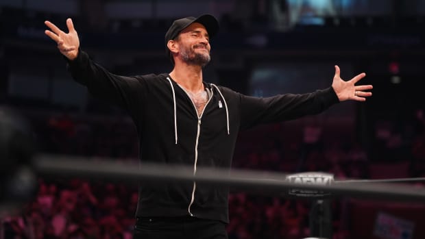 AEW's CM Punk greets the crowd before a promo