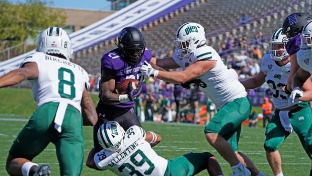 Sep 25, 2021; Evanston, Illinois, USA; Northwestern Wildcats running back Anthony Tyus III (27) runs the ball as Ohio Bobcats safety Michael Ballentine (39) tackles him during the first half at Ryan Field. Mandatory Credit: David Banks-USA TODAY Sports