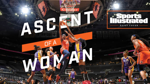Jonquel Jones driving to the basket with the words Ascent of a Woman