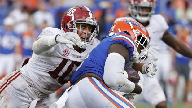 Sep 18, 2021; Gainesville, Florida, USA; Alabama Crimson Tide linebacker Henry To'oTo'o (10) tackles Florida Gators tight end Keon Zipperer (9) during the second half at Ben Hill Griffin Stadium.