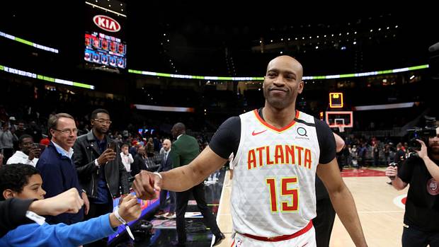 Atlanta Hawks guard Vince Carter (15) fist bumps fans after an overtime loss to the New York Knicks at State Farm Arena.