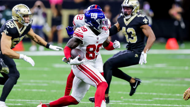 Oct 3, 2021; New Orleans, Louisiana, USA; New York Giants wide receiver Kadarius Toney (89) runs from the tackle of New Orleans Saints linebacker Kaden Elliss (55) during the first half at Caesars Superdome.
