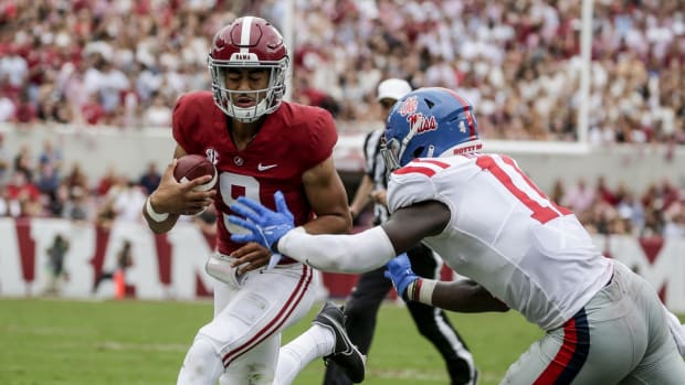 Oct 2, 2021; Tuscaloosa, Alabama, USA; Alabama Crimson Tide quarterback Bryce Young (9) is pushed out of bounds by Mississippi Rebels linebacker Austin Keys (11) during the second half of an NCAA college football game at Bryant-Denny Stadium. Mandatory Credit: Butch Dill-USA TODAY Sports