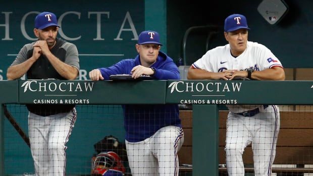 Aug 5, 2021; Arlington, Texas, USA; Texas Rangers manager Chris Woodward (8) and pitching coach Doug Mathis (71) and bench coach Don Wakamatsu (22) watch play in the first inning against the Los Angeles Angels at Globe Life Field. Mandatory Credit: Tim Heitman-USA TODAY Sports