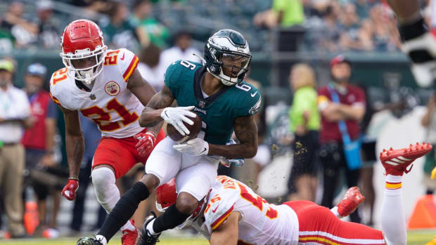 Oct 3, 2021; Philadelphia, Pennsylvania, USA; Philadelphia Eagles wide receiver DeVonta Smith (6) makes a catch in front of Kansas City Chiefs cornerback Mike Hughes (21) and linebacker Ben Niemann (56) during the fourth quarter at Lincoln Financial Field. Mandatory Credit: Bill Streicher-USA TODAY Sports