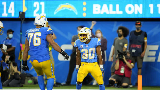 Oct 4, 2021; Inglewood, California, USA; Los Angeles Chargers running back Austin Ekeler (30) celebrates with offensive guard Oday Aboushi (76) after scoring a touchdown against the Las Vegas Raiders during the second half at SoFi Stadium. Mandatory Credit: Robert Hanashiro-USA TODAY Sports