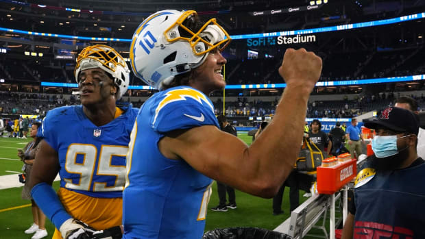 Oct 4, 2021; Inglewood, California, USA; Los Angeles Chargers quarterback Justin Herbert (10) and defensive end Christian Covington (95) react after defeating the Las Vegas Raiders at SoFi Stadium. Mandatory Credit: Kirby Lee-USA TODAY Sports